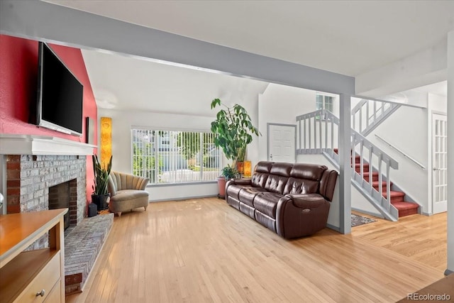 8060 Meadowdale Sq, Niwot, CO 80503 - living area with wood finished floors, stairs, and a fireplace