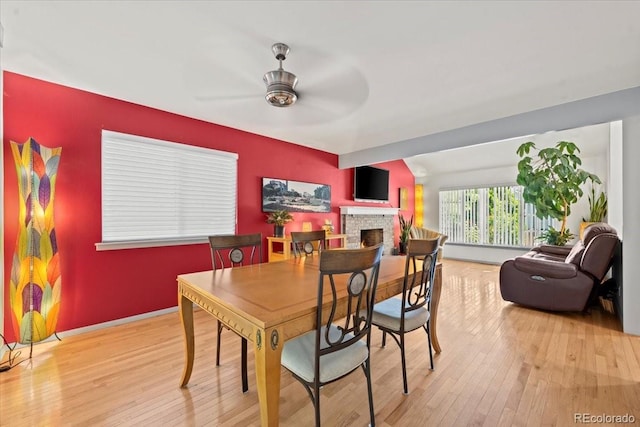 8060 Meadowdale Sq, Niwot, CO 80503 - dining space with a ceiling fan, wood finished floors, and a fireplace
