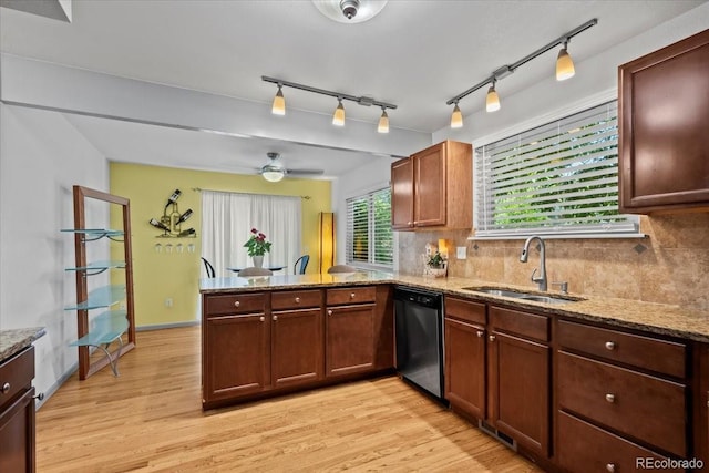 8060 Meadowdale Sq, Niwot, CO 80503 - kitchen with stainless steel dishwasher, a peninsula, light wood-style floors, and tasteful backsplash