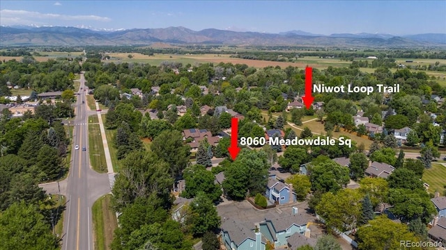 8060 Meadowdale Sq, Niwot, CO 80503 - aerial view of property and surrounding area with a mountainous background and nearby suburban area