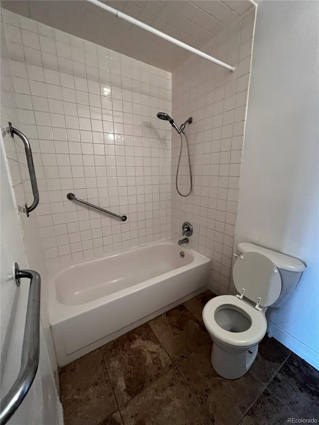 bathroom with tiled shower / bath combo, toilet, and tile floors