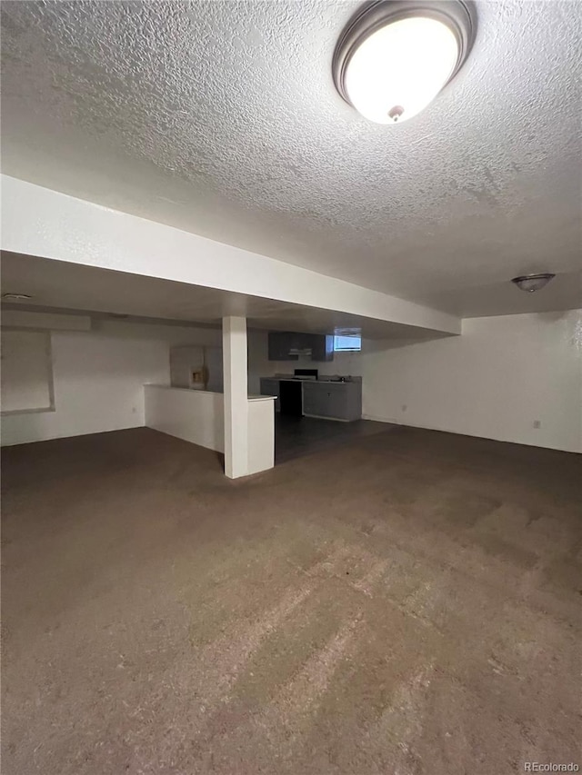 basement featuring a textured ceiling