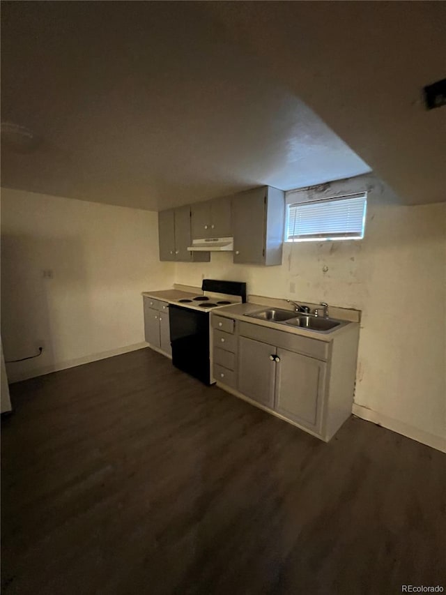 kitchen featuring sink, dark hardwood / wood-style flooring, white range with electric cooktop, and gray cabinetry