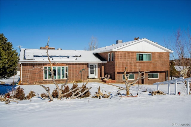 view of snow covered rear of property