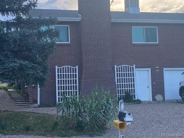 outdoor building at dusk with a garage