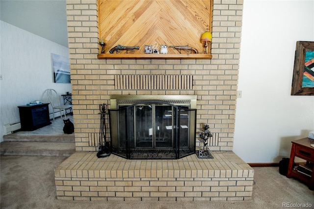 interior details featuring baseboard heating, carpet flooring, and a fireplace