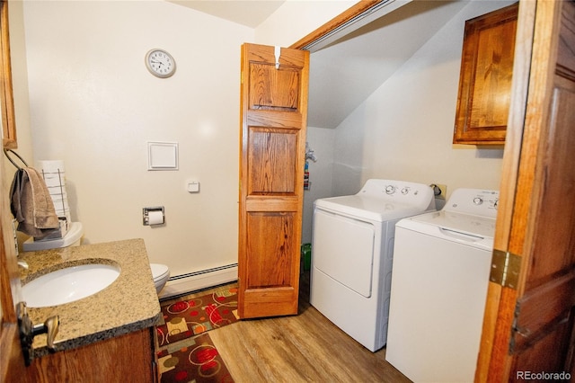 washroom featuring a baseboard radiator, light hardwood / wood-style flooring, sink, and independent washer and dryer