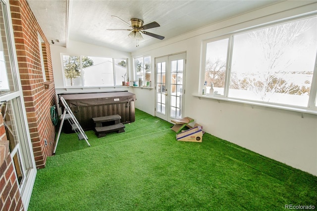 unfurnished sunroom with ceiling fan, french doors, and a hot tub