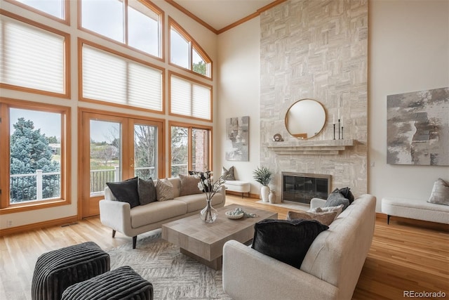 101 Glenmoor Ln, Cherry Hills Village, CO 80113 - living room with a towering ceiling, a stone fireplace, ornamental molding, and wood finished floors