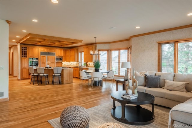 101 Glenmoor Ln, Cherry Hills Village, CO 80113 - living area featuring ornamental molding, healthy amount of natural light, light wood-type flooring, a chandelier, and recessed lighting