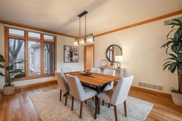 101 Glenmoor Ln, Cherry Hills Village, CO 80113 - dining space featuring wood finished floors and crown molding