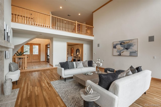 101 Glenmoor Ln, Cherry Hills Village, CO 80113 - living area featuring light wood finished floors, a high ceiling, stairs, and recessed lighting