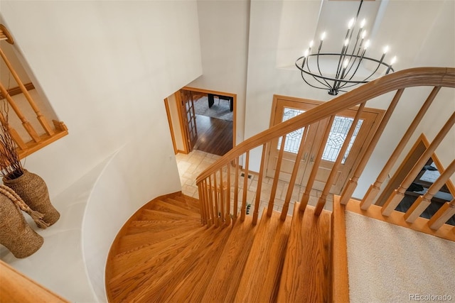 101 Glenmoor Ln, Cherry Hills Village, CO 80113 - stairway with a high ceiling, wood finished floors, and a chandelier