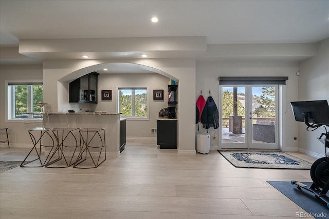 living room with plenty of natural light, recessed lighting, and baseboards