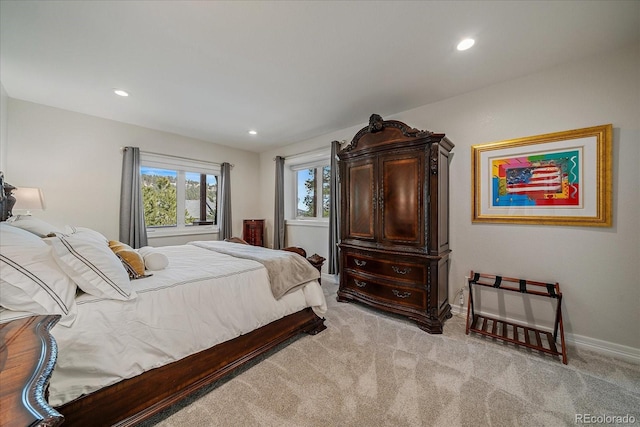 bedroom featuring light carpet, recessed lighting, and baseboards