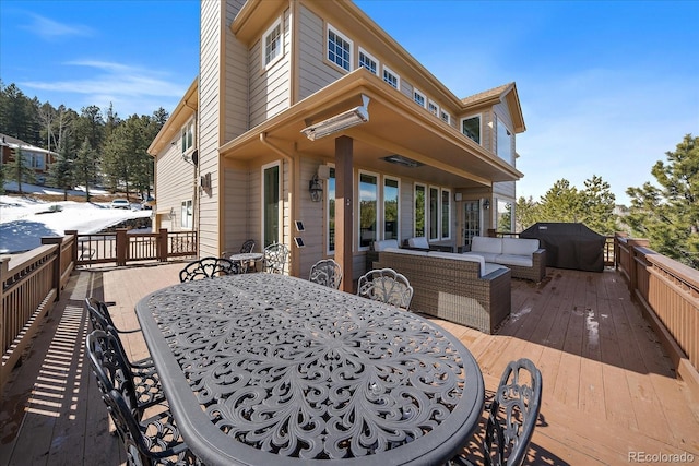 wooden terrace featuring outdoor dining space, an outdoor living space, and grilling area