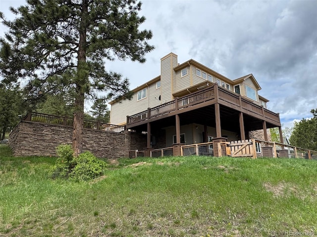 1366 Killington Ct, Evergreen, CO 80439 - rear view of house with a chimney, a deck, and stone siding