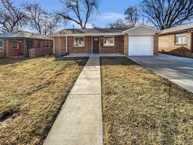 ranch-style home with a front lawn, fence, concrete driveway, a garage, and brick siding