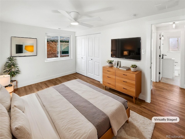 bedroom with a ceiling fan, wood finished floors, and a closet