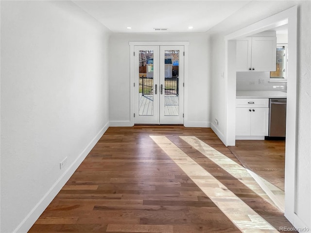 entryway with visible vents, baseboards, wood finished floors, and french doors