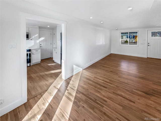 interior space with recessed lighting, baseboards, and wood finished floors