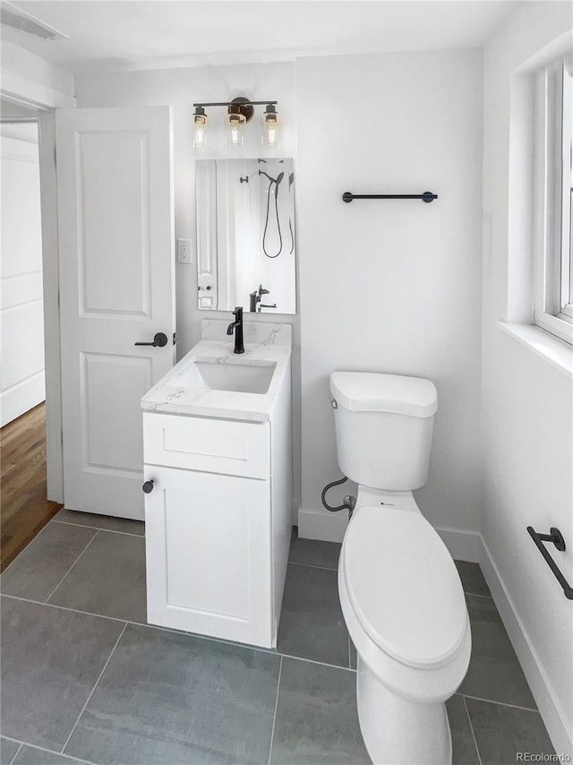 bathroom with tile patterned floors, visible vents, toilet, baseboards, and vanity