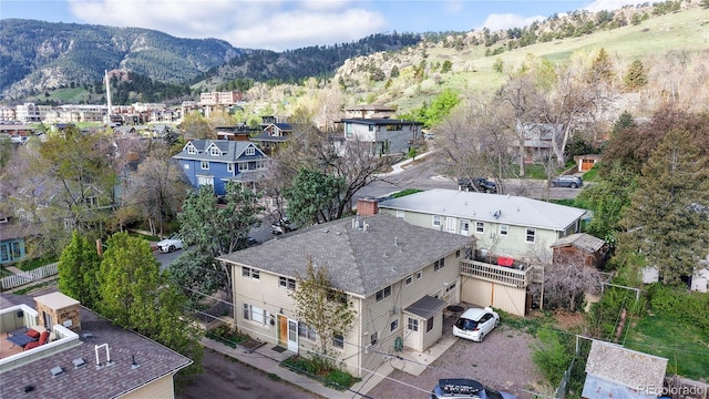 drone / aerial view featuring a residential view and a mountain view