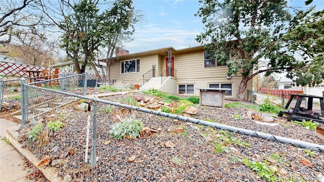 view of front of property featuring fence and a gate