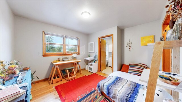 bedroom featuring baseboards and wood finished floors