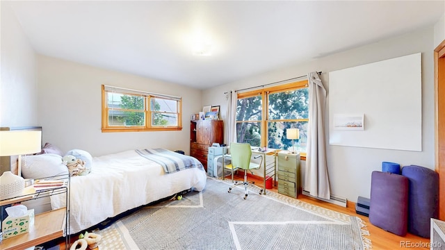 bedroom featuring light wood-style flooring and multiple windows