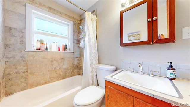 full bath with toilet, shower / bathtub combination with curtain, and vanity