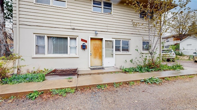 exterior space featuring stucco siding and fence