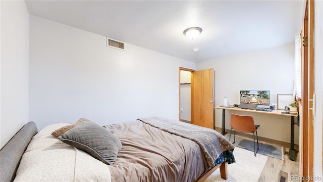 bedroom featuring light wood-style flooring and visible vents