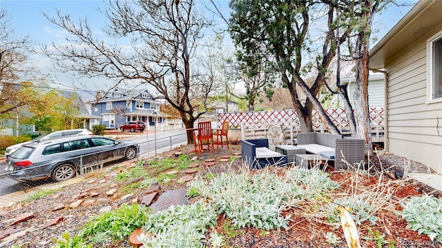 view of yard featuring fence and a residential view