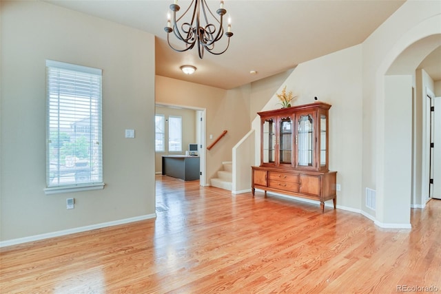 entryway with an inviting chandelier and light hardwood / wood-style floors