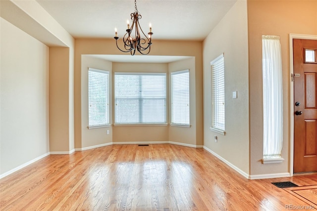 interior space with a notable chandelier and light wood-type flooring