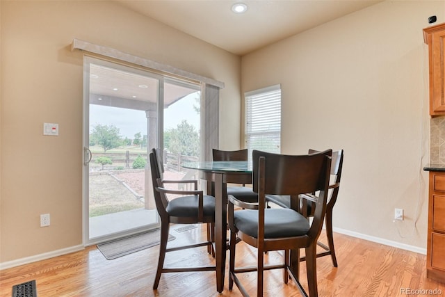 dining area with light hardwood / wood-style floors