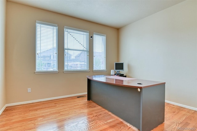 office area with light hardwood / wood-style floors