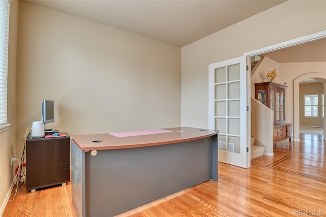 home office with light hardwood / wood-style flooring