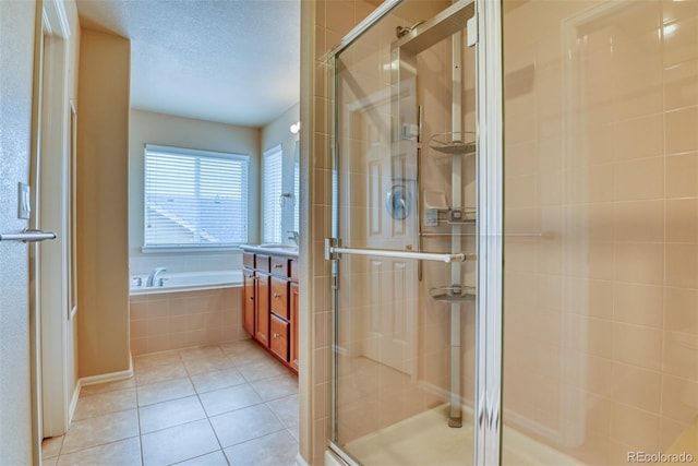 bathroom featuring tile patterned flooring, sink, and separate shower and tub