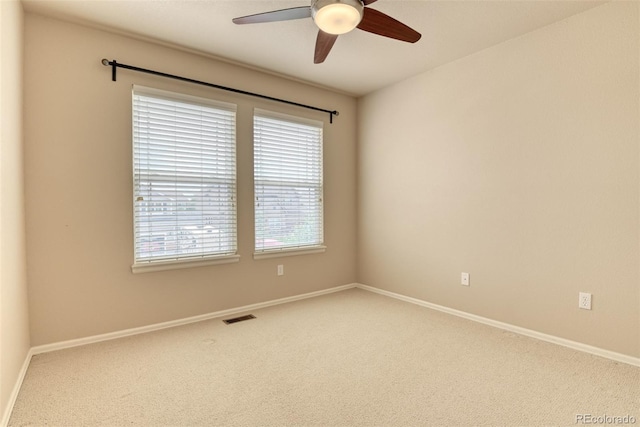 empty room featuring carpet and ceiling fan