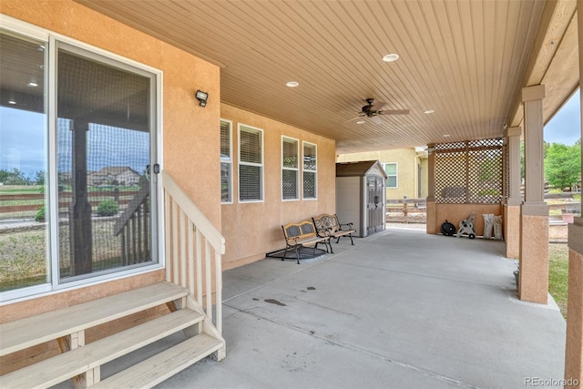 view of patio / terrace featuring a shed and ceiling fan