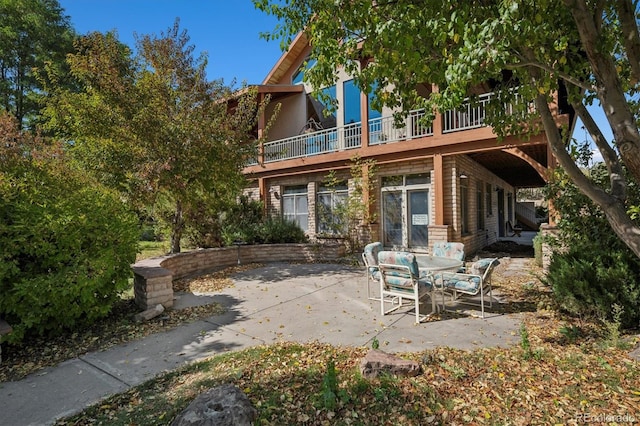 back of house featuring a patio and a balcony