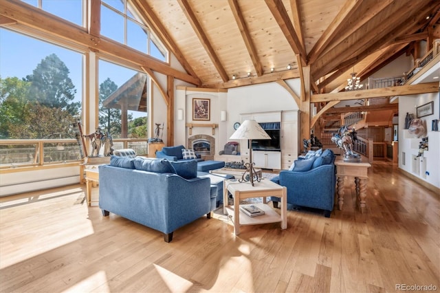 living room featuring light hardwood / wood-style flooring, high vaulted ceiling, wood ceiling, and beam ceiling