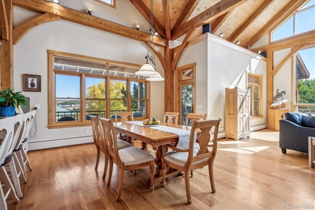 dining room featuring beam ceiling, high vaulted ceiling, a baseboard radiator, and light wood-type flooring