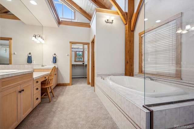 bathroom featuring baseboard heating, vanity, lofted ceiling with skylight, and a relaxing tiled tub