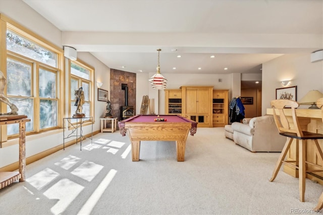 rec room featuring light colored carpet, a wood stove, and pool table