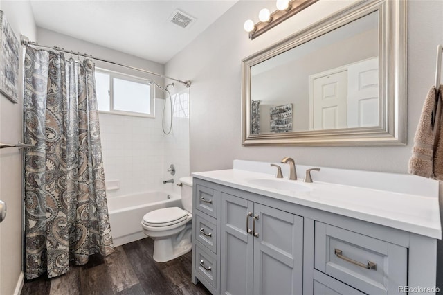 full bathroom with vanity, hardwood / wood-style flooring, toilet, and shower / bathtub combination with curtain