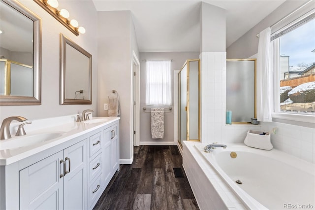 bathroom featuring hardwood / wood-style floors, vanity, and separate shower and tub