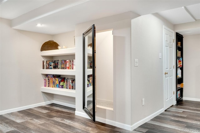 hallway with dark hardwood / wood-style flooring